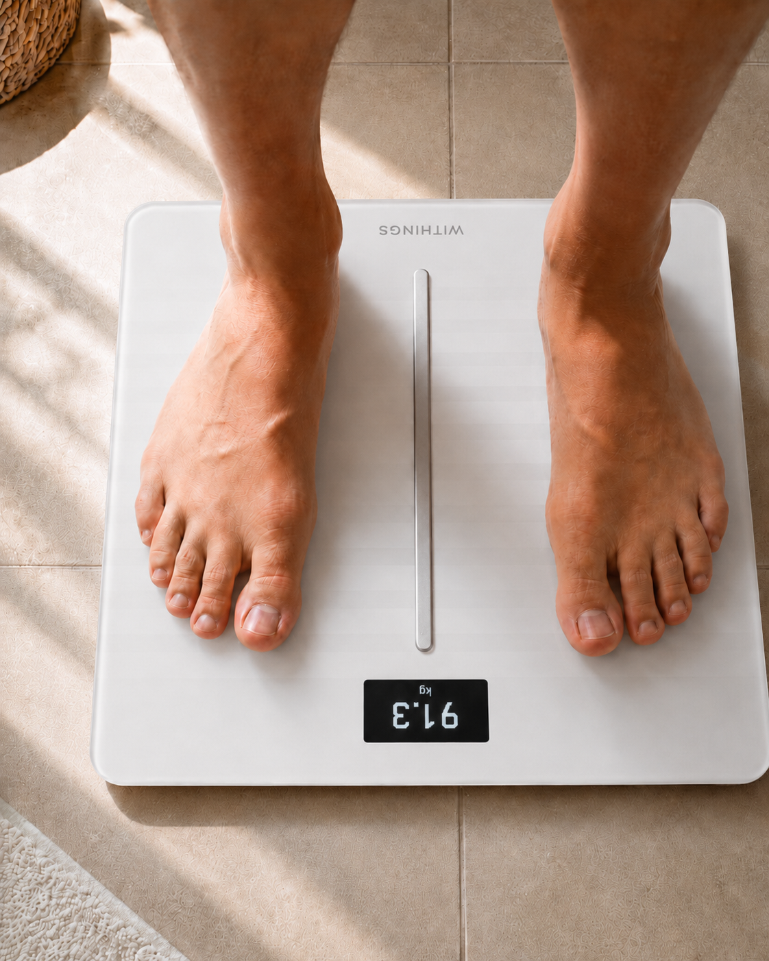 Close-up of feet on a digital bathroom scale — weight management journey